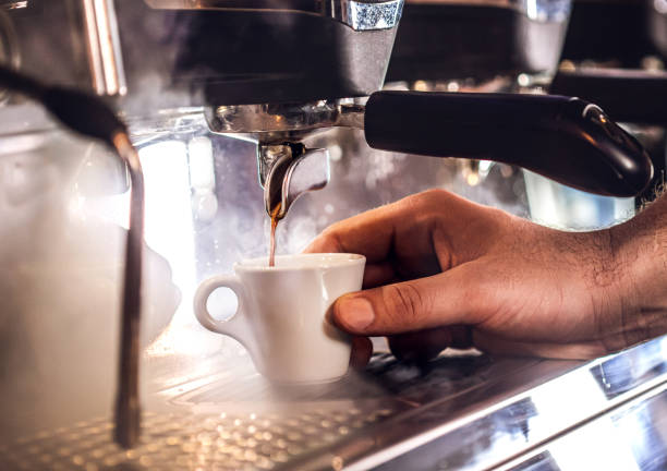 istock Man preparing coffee at table in cafe 1450067315