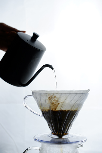 barista pouring water into v60