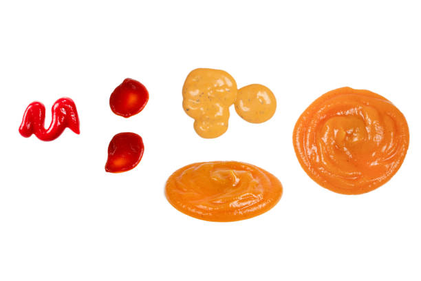 istock Red sauce splashes isolated on white background. Ketchup. 1450074455