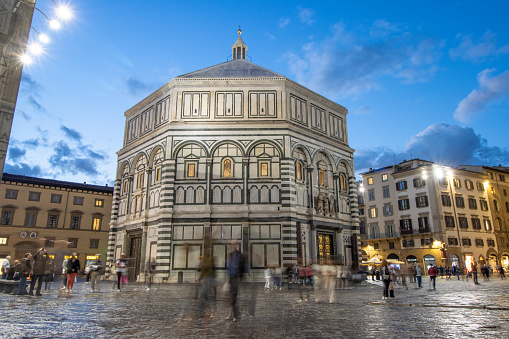 People walking around outside the Baptistery of St John at Piazza del Duomo of Florence in Tuscany, Italy