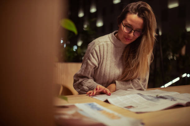 istock The woman is having fun reading the newspaper 1450081752