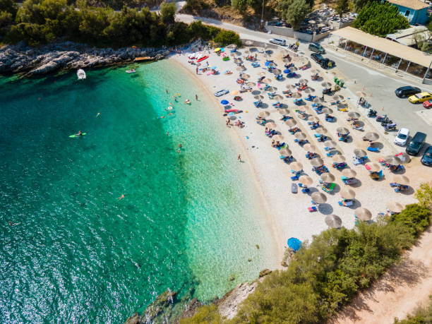 istock Lefkada island beach overhead view people on sun loungers 1450083534