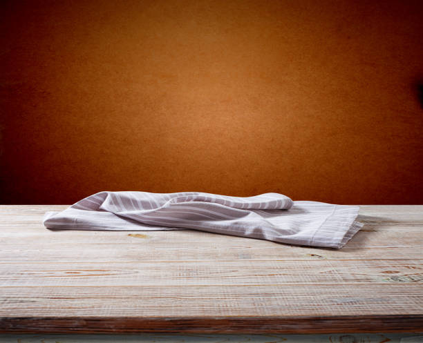 istock White napkin, table cloth on wooden deck mockup. 1450084314