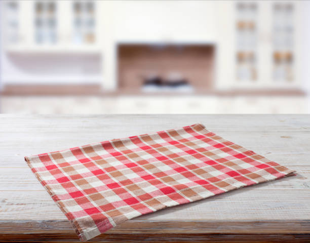 istock Folded towel, linen tablecloth on wooden desk perspective. Selective focus. 1450084355