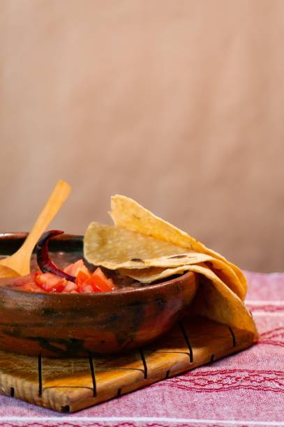 istock Beans cooked in a clay dish with tomato and tortillas, mexican poor dish 1450086888