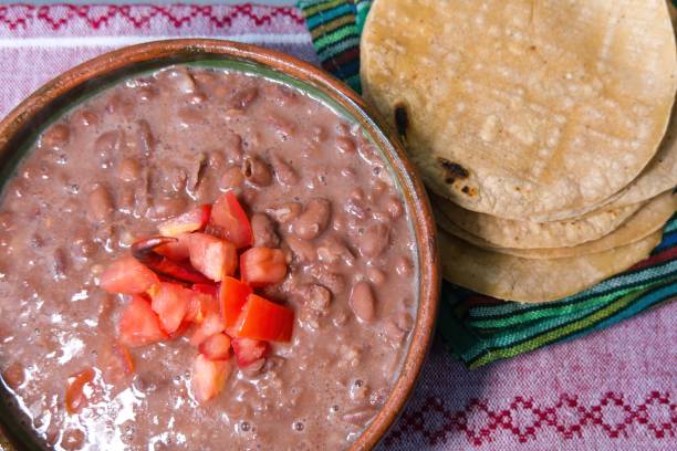 istock Beans cooked in a clay dish with tomato and tortillas, mexican poor dish 1450086904
