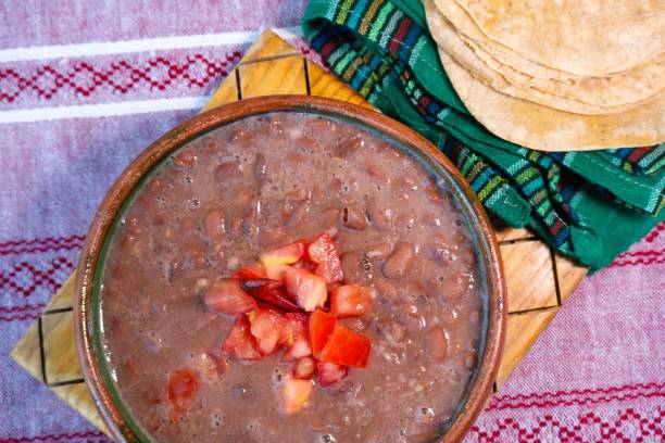 istock Beans cooked in a clay dish with tomato and tortillas, mexican poor dish 1450086908