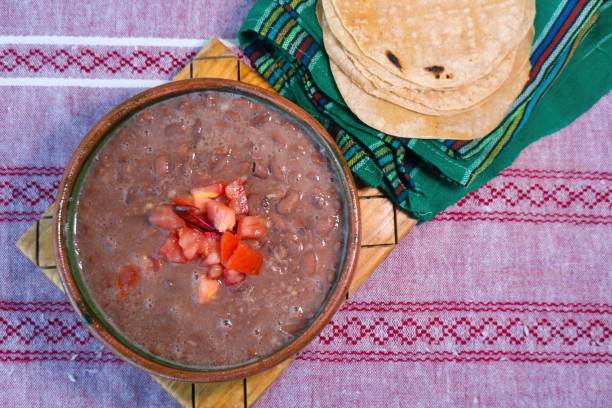 istock Beans cooked in a clay dish with tomato and tortillas, mexican poor dish 1450086913