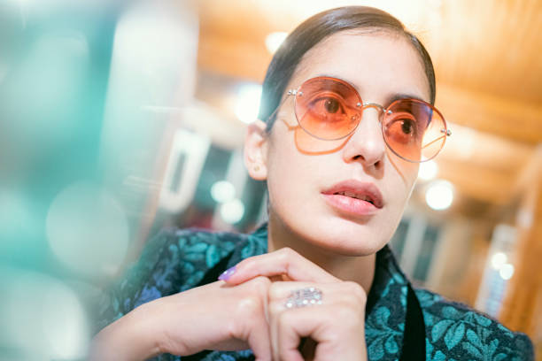 bachelorette young woman takes a break in a cafe. - tinted sunglasses imagens e fotografias de stock