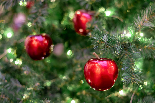 A Christmas tree decorated with red apples. Postcard. Congratulation