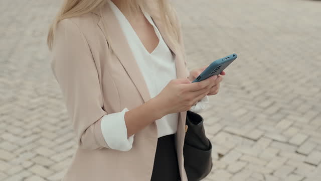 Young Businesswoman in Smart Casualwear Texting in Smartphone