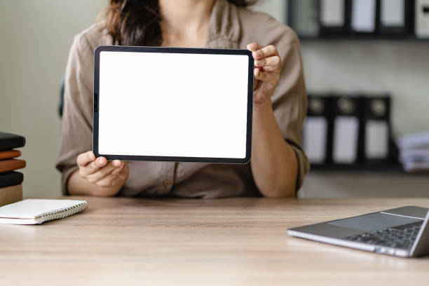 istock Woman holding tablet with white screen for advertisement 1450095897