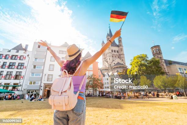 A Young Happy Tourist Or Student Girl With A German Flag At The Old Town Or Altstadt In Cologne Fish Market Square Studying Language Abroad And Traveling Concept Stock Photo - Download Image Now