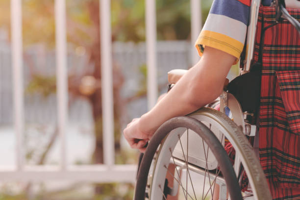 Positive photography of people with disability, concept Good mental health with sun nature light. Arm of young man with disability sitting look at the sun on nature background on balcony of home or hospital,school,nursery with sunlight at sunset Positive photography and Good mental health concept. broken spring stock pictures, royalty-free photos & images