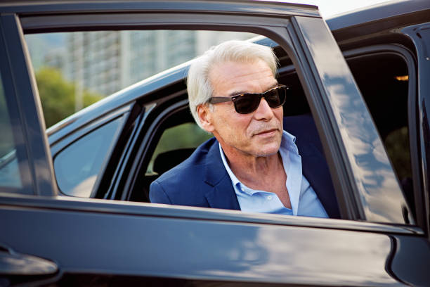 istock Businessman is entering/exiting a car 1450100441