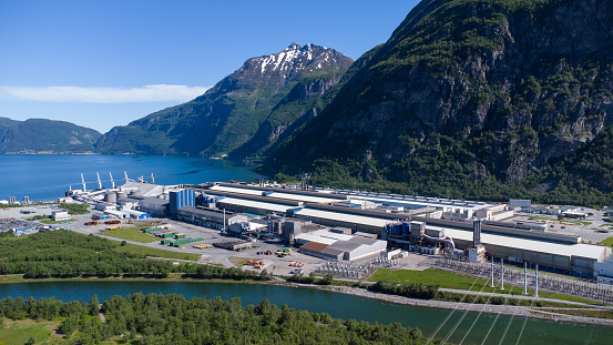 Sunndalsøra, Norway - June 19, 2022: Aerial view of the Hydro Norse aluminium production facility placed in a beautiful landscape