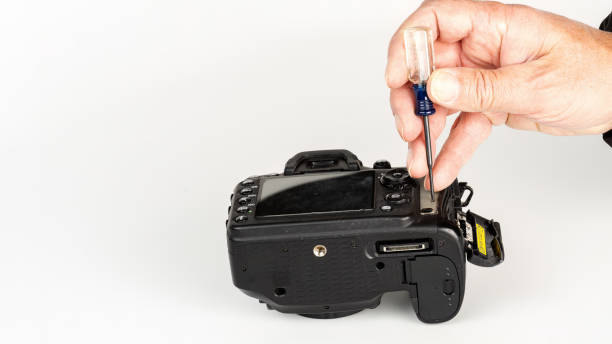 istock Camera mechanic works to fix a DSLR 1450101446