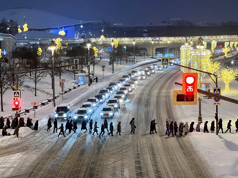 People crossing street in Moscow city center, Moskva river embankment