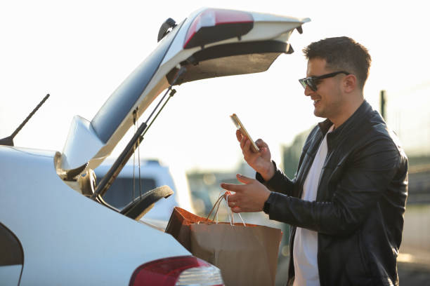 istock Young Man Shopping, Using Phone , Texting, City Life 1450105102