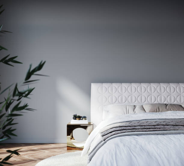 istock Modern bedroom design with white bed and empty gray mock up wall background 1450105153