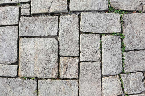 Cobblestone paving slab texture and background. Granite block paving stone.