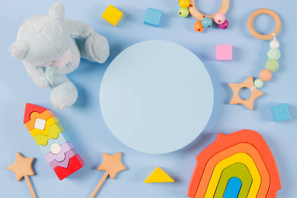 istock Empty round platform podium stand, teddy bear and natural wooden ecological sustainable educational toys on light blue background. Montessori, eco-friendly toys for children. Top view, flat lay 1450113131