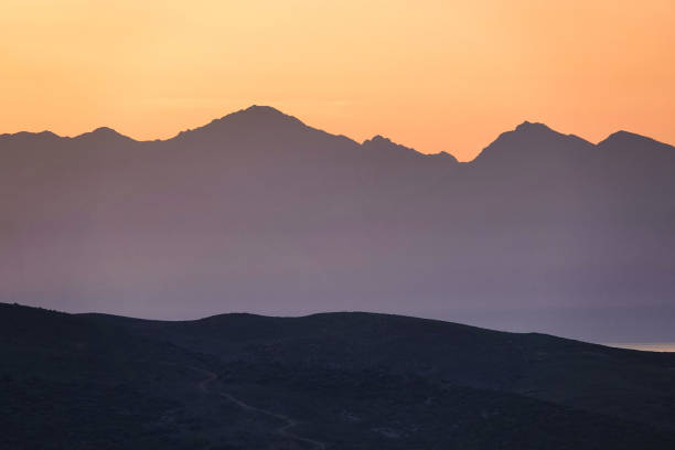 orange sunset between two mountains. mountain silhouette at sunset or dawn