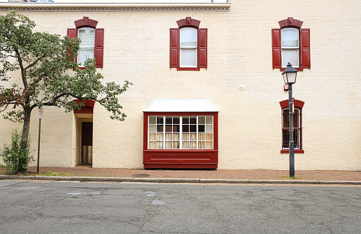 An exterior wall of a building with red trim in Alexandria, Virginia