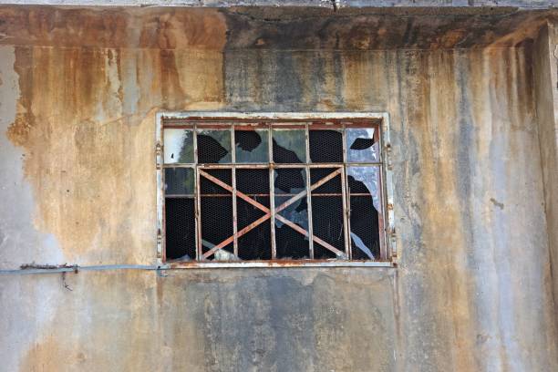 istock Closeup view of a broken window in an abandoned house 1450122700
