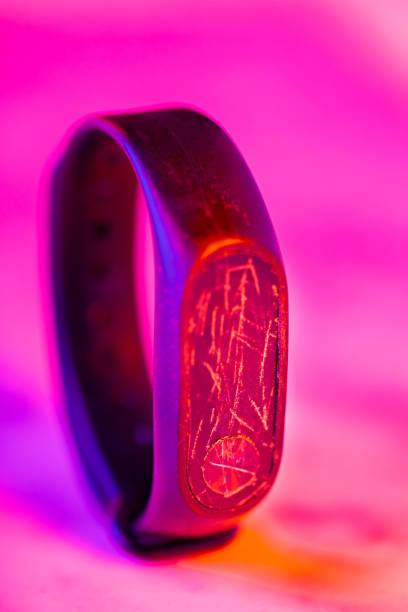 istock Smart watch with broken display in neon light. Fitness tracker with cracked screen. Repair service 1450122704