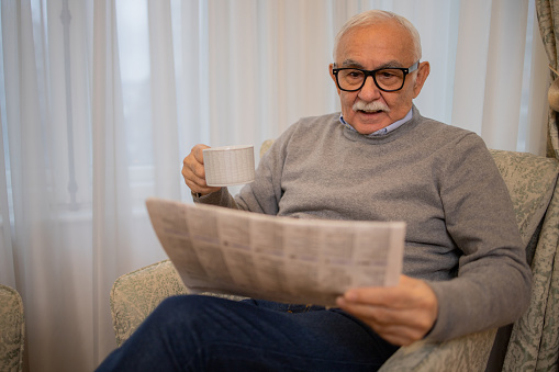 Old man reading newspapers