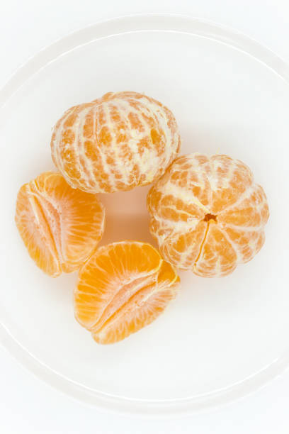 istock peeled from the upper skin tangerines on white plate. 1450125050