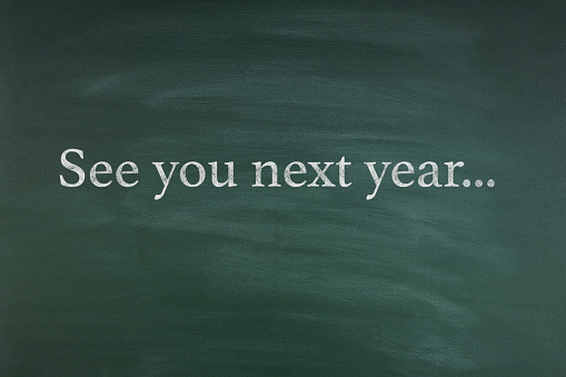 See you next year text on the chalkboard with copy space