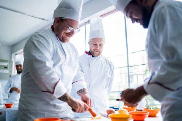 istock Coworkers cooking together in a commercial kitchen 1450126878