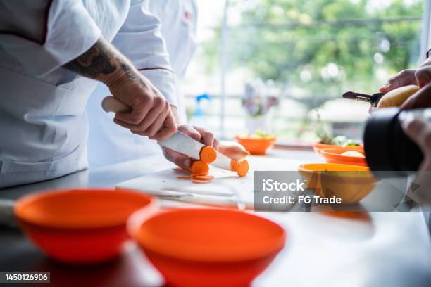Chef Chopping Carrots In A Domestic Kitchen Stock Photo - Download Image Now - Food And Drink Industry, Food Service Occupation, Food and Drink
