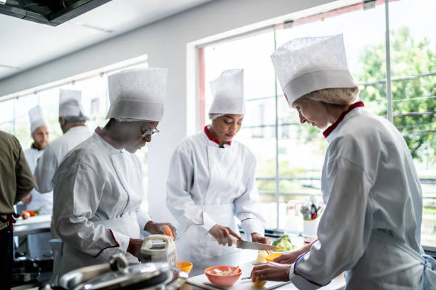 istock Coworkers cooking together in a commercial kitchen 1450127071