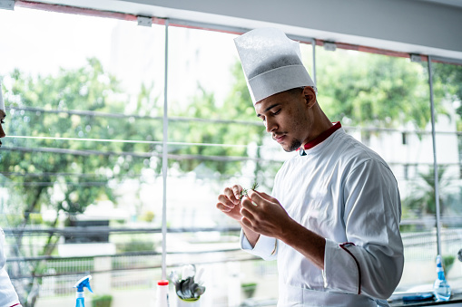Chef analyzing some herbs in a commercial kitchen