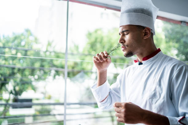 istock Chef smelling a branch of rosemary 1450127117