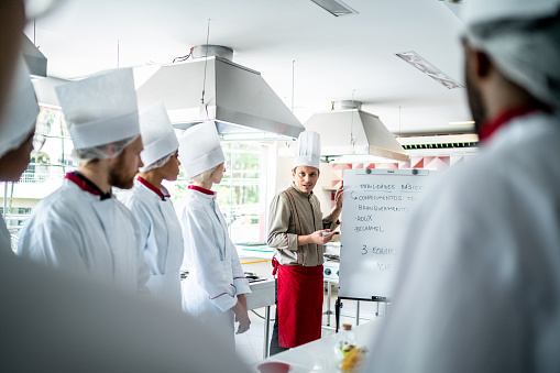 Chef teaching students during cooking class
