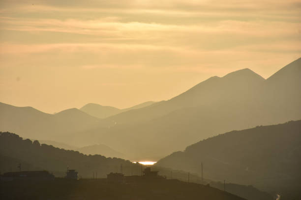 istock tectonic mountain silhouettes, a dam lake between mountains at night or dawn 1450127184