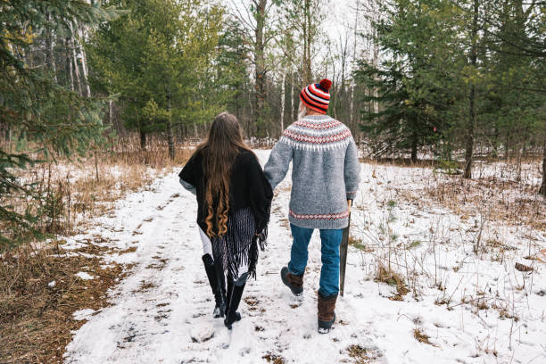 istock Mature couple looking for Christmas tree in the woods 1450129830
