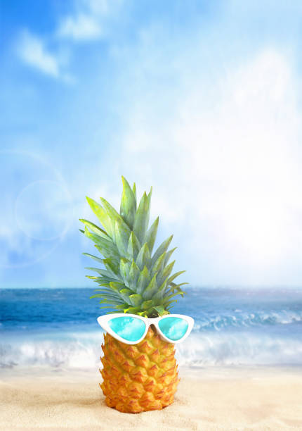 istock Pineapple with sunglasses on tropical beach background. Summer beach concept. 1450130523