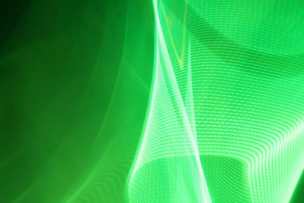 An abstract illustration of neon glowing waves, in green and white, with light trails