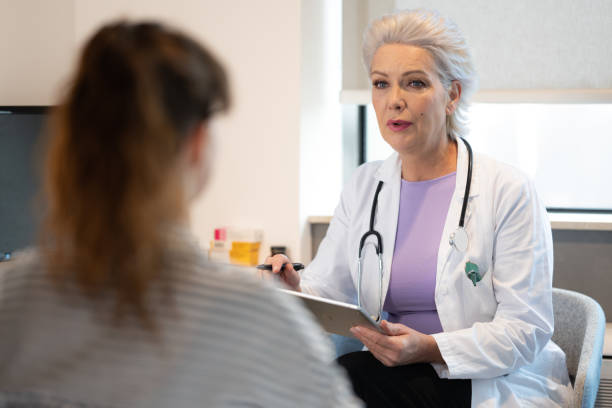 istock White female doctor talking to patient in her office 1450131777