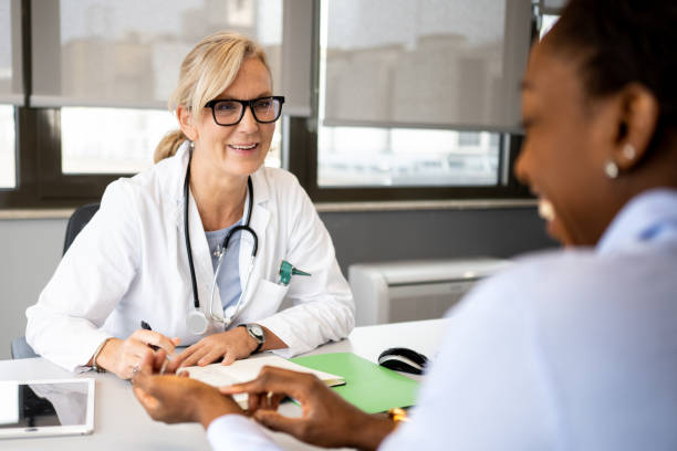istock White female doctor talking to patient in her office 1450132143