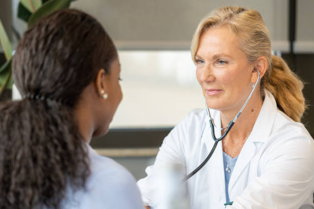istock Doctor checking a black woman's breathing and heartbeat 1450132251