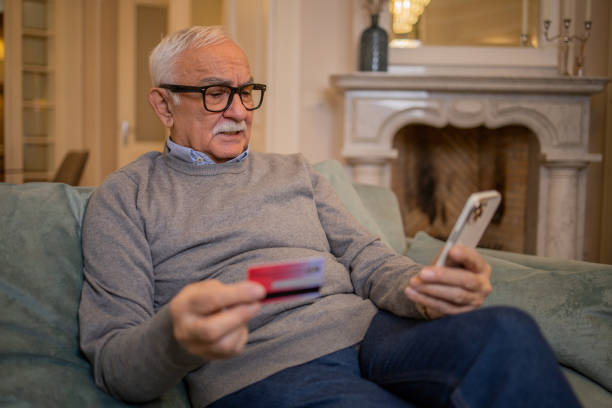 istock Man using her credit card to shop online 1450132393