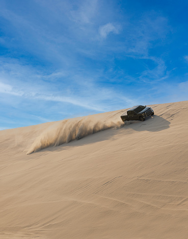 Desert Safari, a black SUV is bashing through the arabian sand dunes in Doha, Qatar