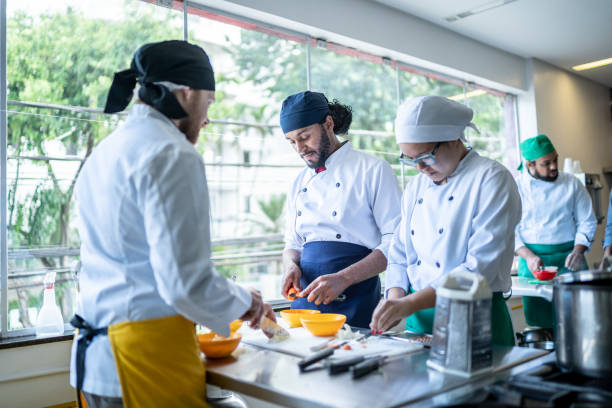 istock Coworkers cooking together in a commercial kitchen 1450132474