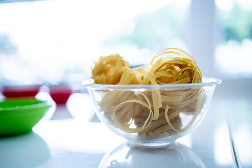 Bowl with raw pasta in a commercial kitchen